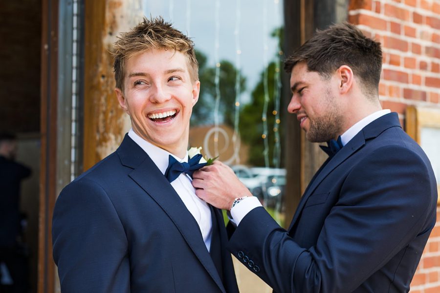 Southwood Hall wedding, bowties being put on by groom